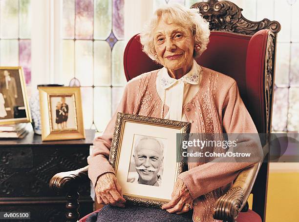 portrait of an elderly widow holding a photograph of her dead husband - handlebar moustache stock pictures, royalty-free photos & images