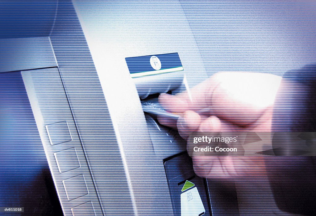 Close up Video Still of An Adult inserting a Bank Card into a Cash Machine