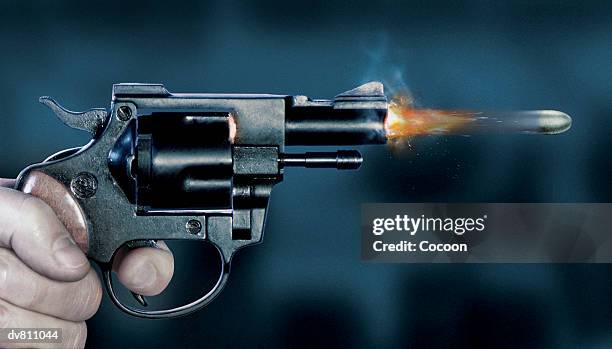 close up of a bullet coming out of a gun - fastest gun ストックフォトと画像