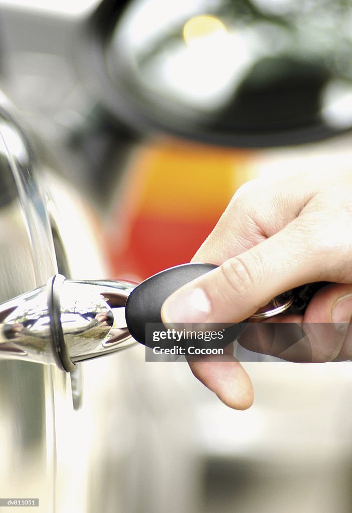 Hand inserting a Key into a Car Door