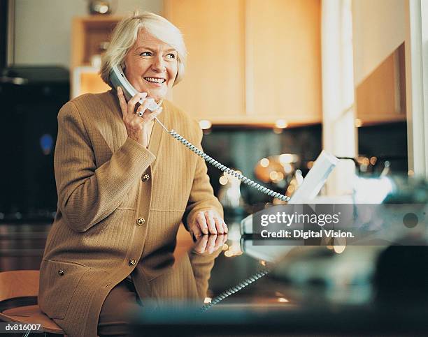 woman on the telephone - landline phone home stock pictures, royalty-free photos & images
