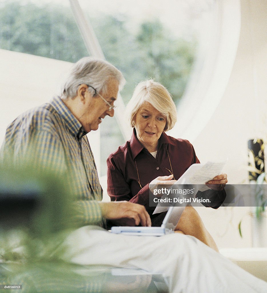 Mature Couple Working at Home