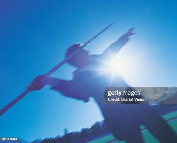 businessman throwing a javelin - mens field event stockfoto's en -beelden