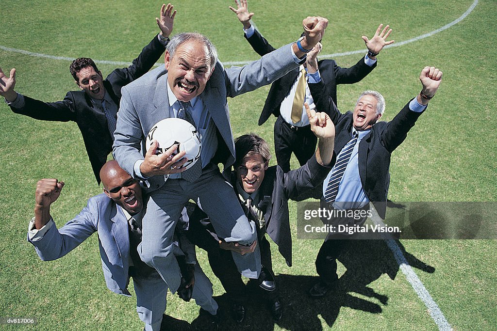 Cheering Businessmen Playing Soccer