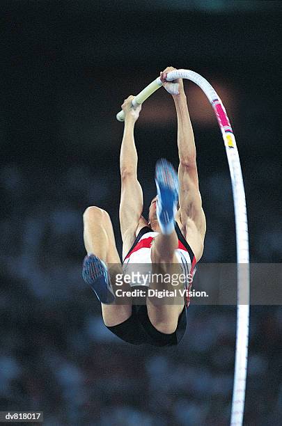 man in a pole vault competition - pole vault stock pictures, royalty-free photos & images