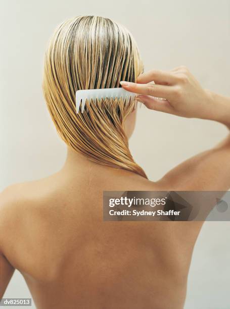 woman coming wet hair - combing stock pictures, royalty-free photos & images