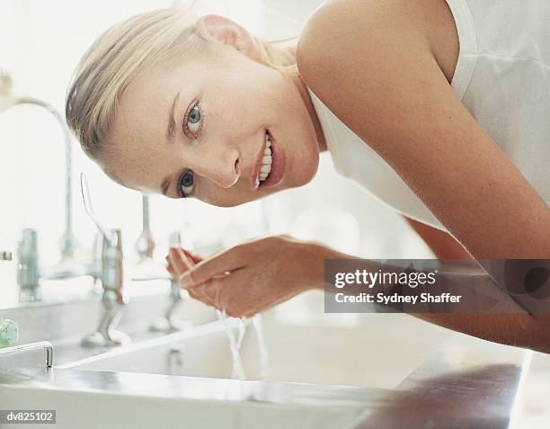 woman washing face - woman washing face stockfoto's en -beelden