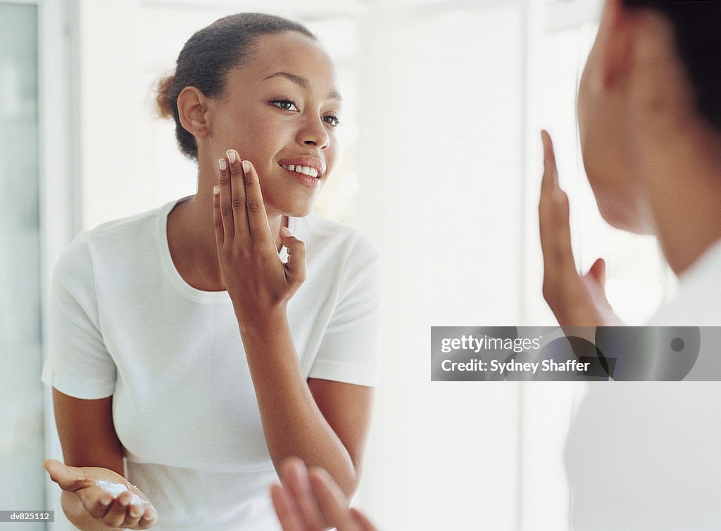 Woman Applying Moisturizer