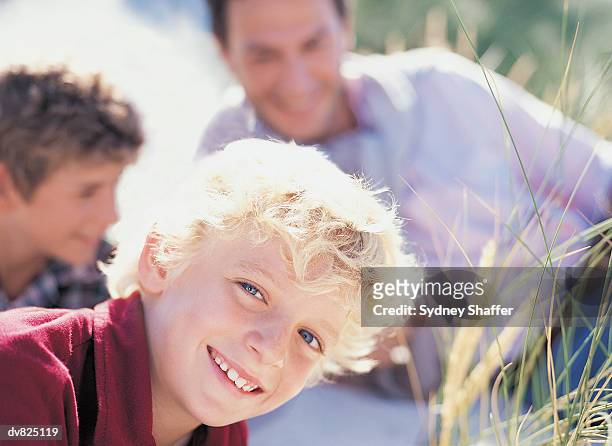 portrait of a young boy in front of his brother and father on the dunes - sydney fotografías e imágenes de stock