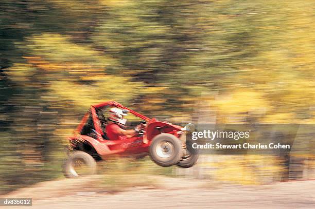 blurred image of person driving go cart over incline - stewart stock-fotos und bilder