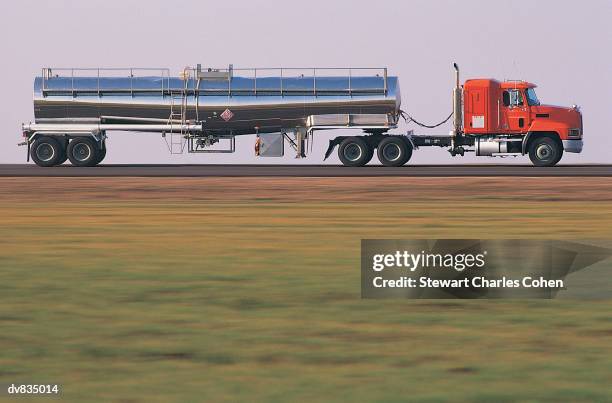 tanker travelling along road - mitziehen stock-fotos und bilder