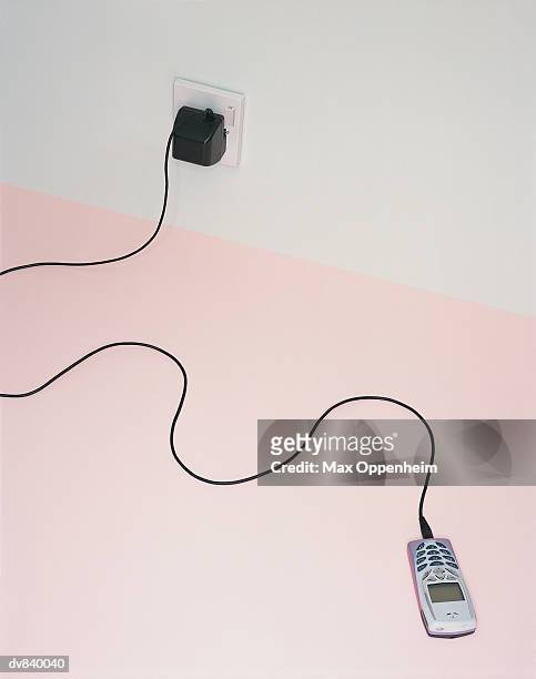 mobile phone being recharged - max stock pictures, royalty-free photos & images