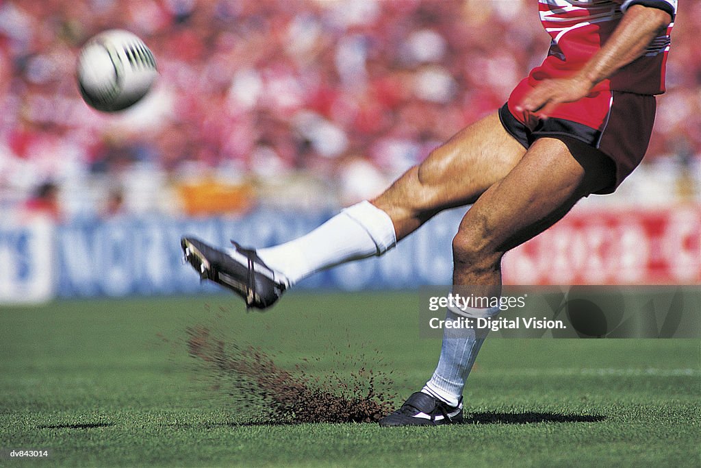 Rugby Player Kicking the Ball