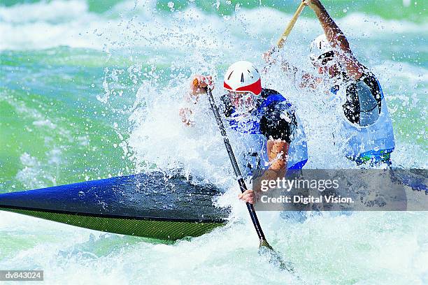 kayakers in whitewater - boat rowing stock pictures, royalty-free photos & images