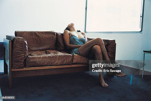 woman relaxing on a sofa - förförisk kvinna bildbanksfoton och bilder