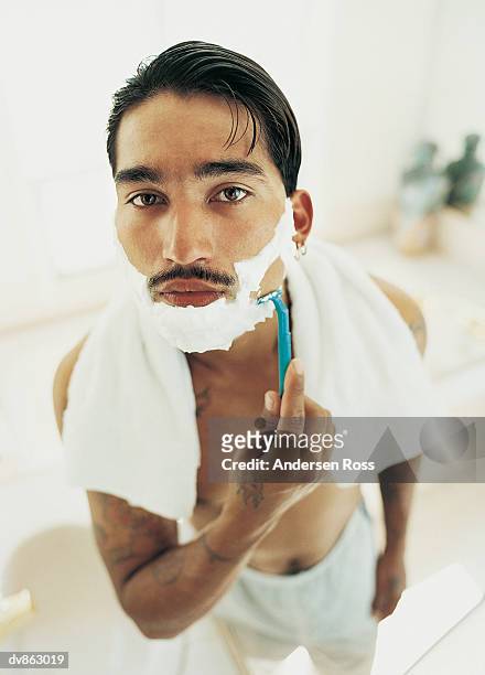 man with a moustache shaving in the bathroom - andersen stock pictures, royalty-free photos & images