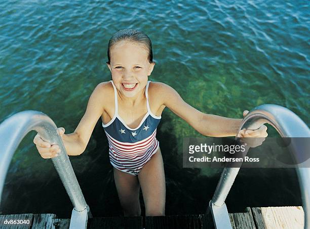 girl climbing out of the water - ross stock pictures, royalty-free photos & images