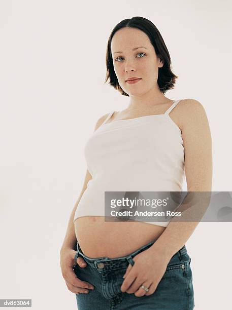 portrait of a pregnant woman standing - andersen stock pictures, royalty-free photos & images