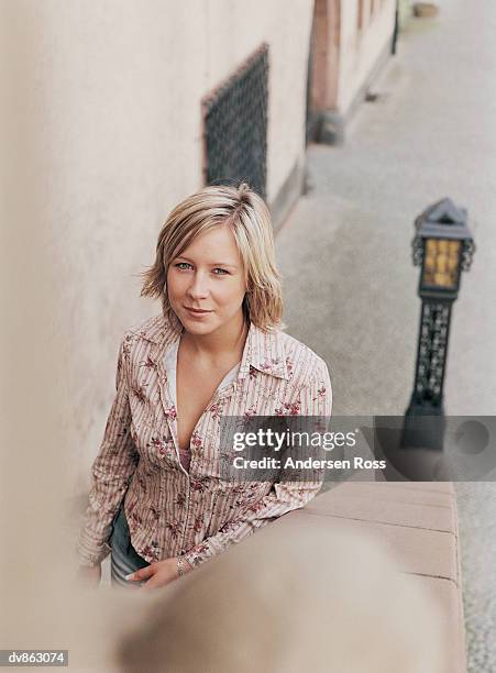 portrait of a young woman standing on stone steps in a city - andersen ross stock pictures, royalty-free photos & images