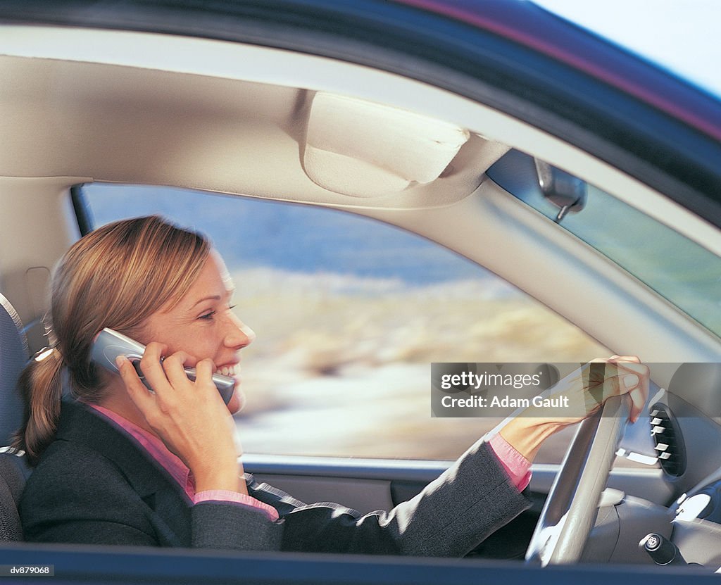 Businesswoman Driving and Using Her Mobile Phone