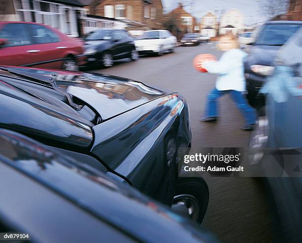 girl running into the street in front of a car - carro de corrida fotografías e imágenes de stock