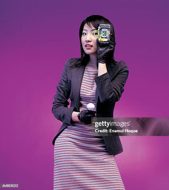 portrait of a woman holding a camera - formal glove stock pictures, royalty-free photos & images