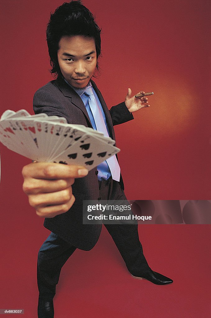 Portrait of a Man Holding Playing Cards
