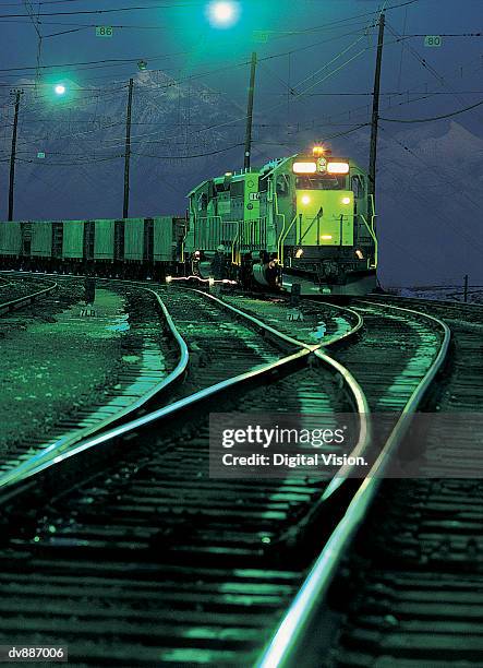 stationary freight train in railway sidings at night - train yard at night stock pictures, royalty-free photos & images