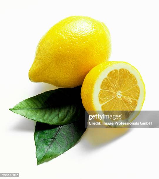 one whole lemon and one half lemon - lemon leaf stock pictures, royalty-free photos & images