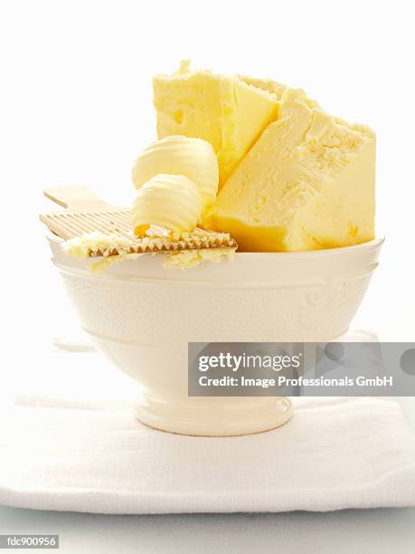 butter with butter curls in a white bowl - butter curl stock pictures, royalty-free photos & images