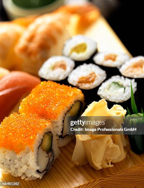 assorted sushi on a wooden board - pickled ginger stock-fotos und bilder