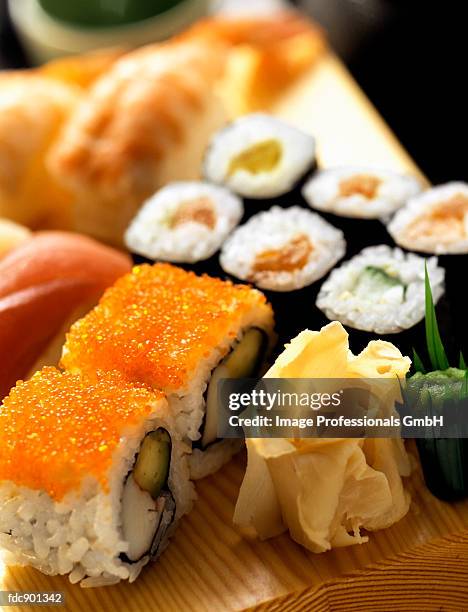 assorted sushi on a wooden board - gari foto e immagini stock