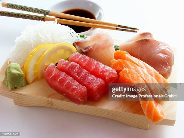 an assortment of sushi on wooden block - fideo transparente fotografías e imágenes de stock