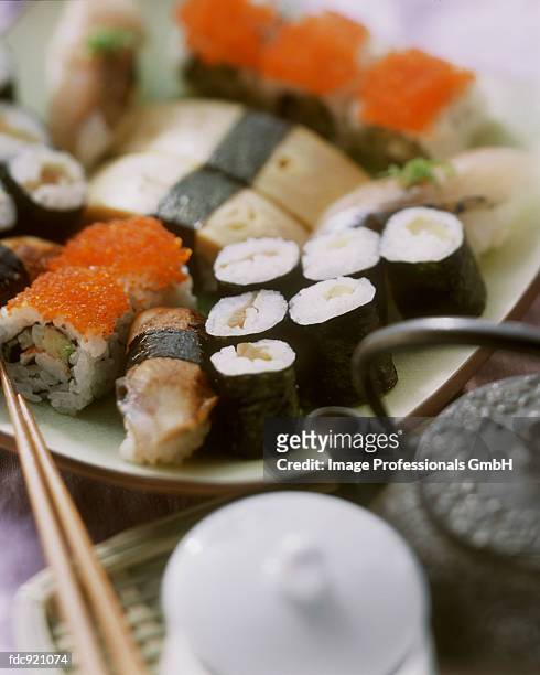 assorted nigiri sushi and maki sushi; teapot - gunkanmaki stock-fotos und bilder