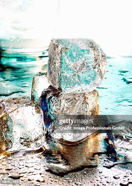 several ice cubes in front of water glass - künstliches eis stock-fotos und bilder