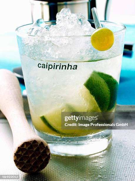 caipirinha with ice cubes; wooden pestle - artificial ice stock pictures, royalty-free photos & images