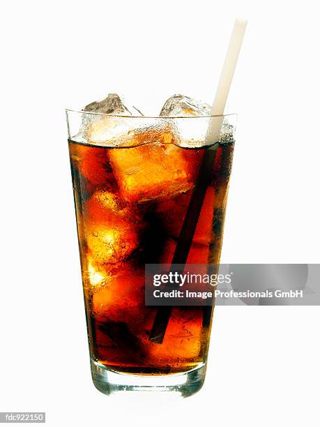 cola with ice cubes and straw in glass - artificial ice stock pictures, royalty-free photos & images