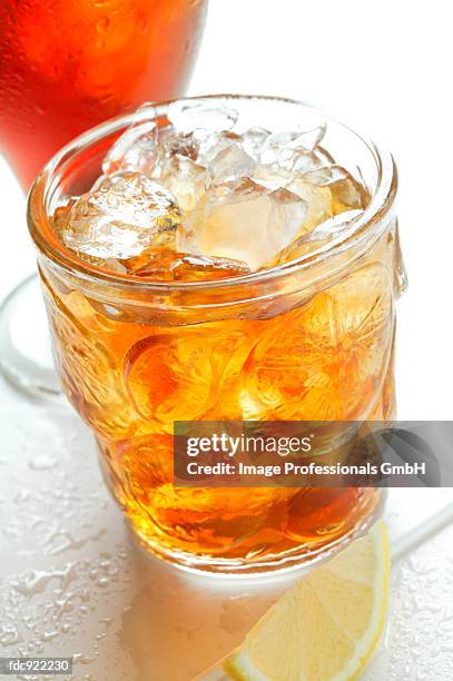 iced teas and wedge of lemon - black tea stock pictures, royalty-free photos & images
