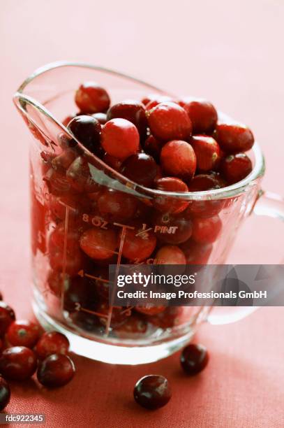 cranberries in measuring jug - measuring jug stock pictures, royalty-free photos & images