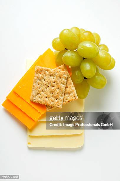 extra sharp cheddar & american cheese with grapes, cracker - cheddar cheese stock pictures, royalty-free photos & images