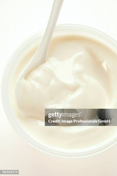 yoghurt in pot with spoon - yoghurt pot stock pictures, royalty-free photos & images