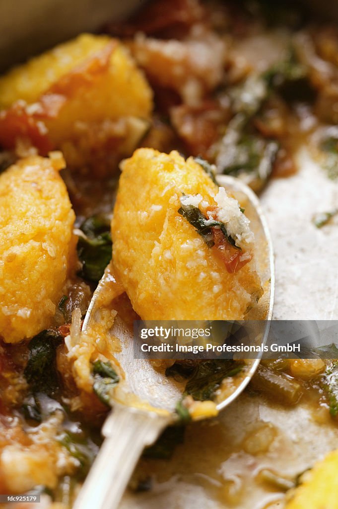 Polenta dumplings with tomatoes, basil and Parmesan