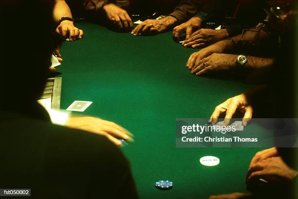 group of people gambling at a casino blackjack table - gambling table stock pictures, royalty-free photos & images