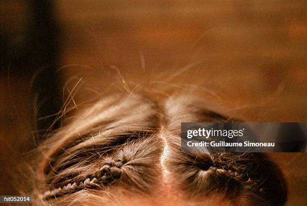 braids in a young woman's hair - hair parting stockfoto's en -beelden