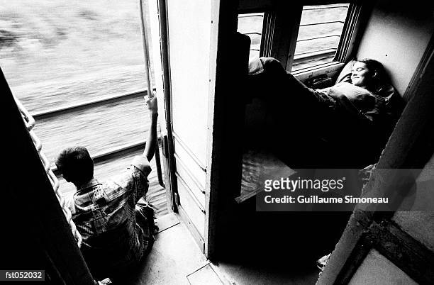 a couple traveling on a train - simoneau stock-fotos und bilder