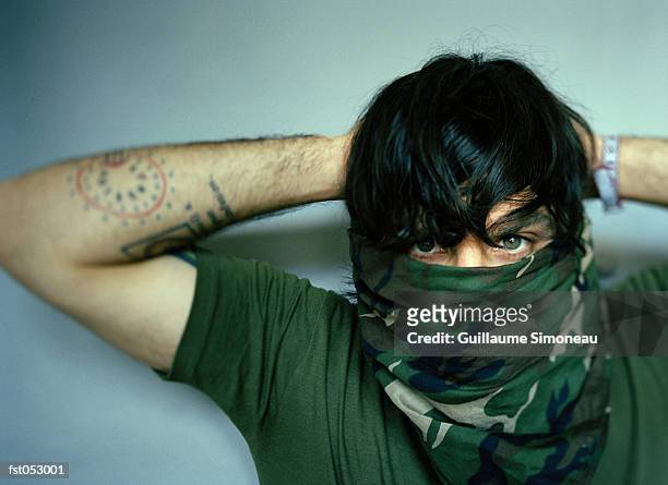 a young man with a bandana covering his face - simoneau stock-fotos und bilder