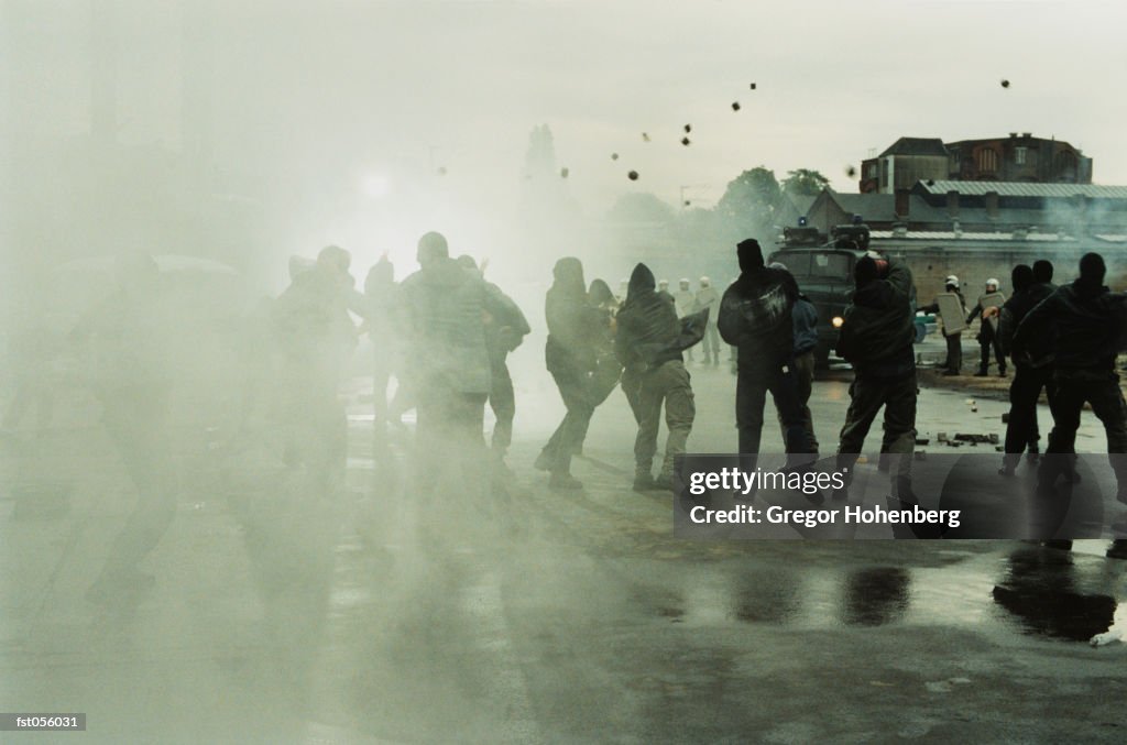 Rioters throwing stones at police