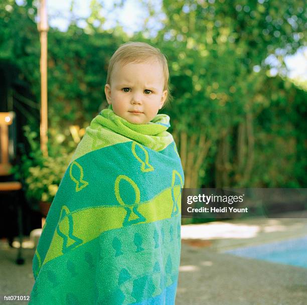 a child wrapped in a towel - heidi stock-fotos und bilder