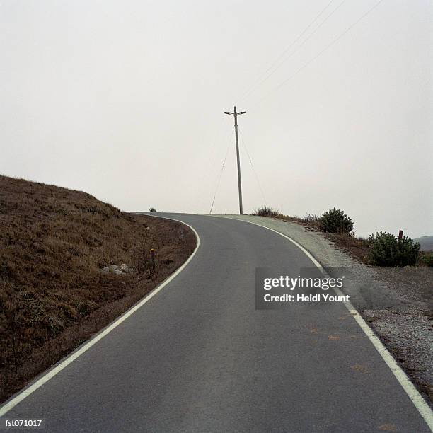 a curved road - heidi stock-fotos und bilder