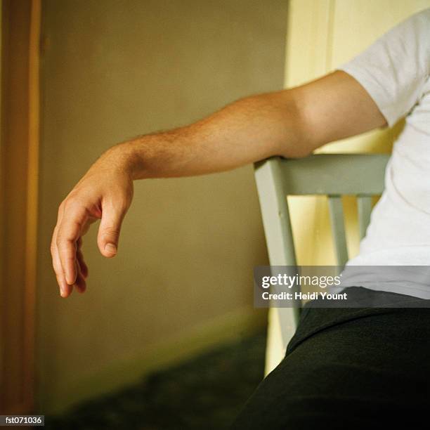 a man sitting on a chair - heidi stock-fotos und bilder
